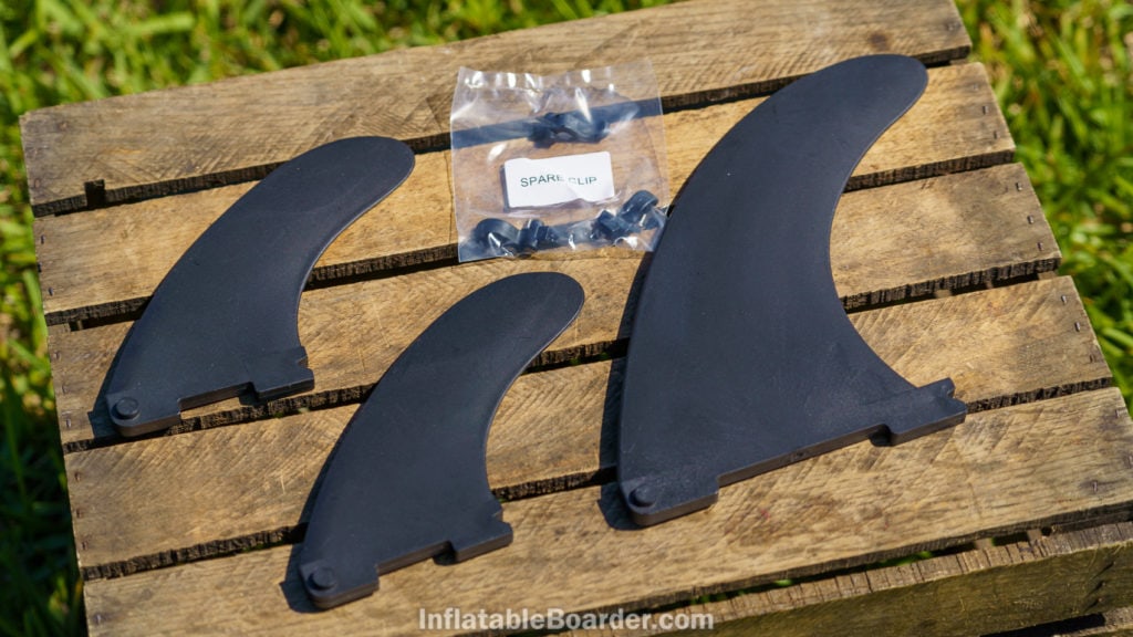 Three black quick-attach fins and included replacement clips.