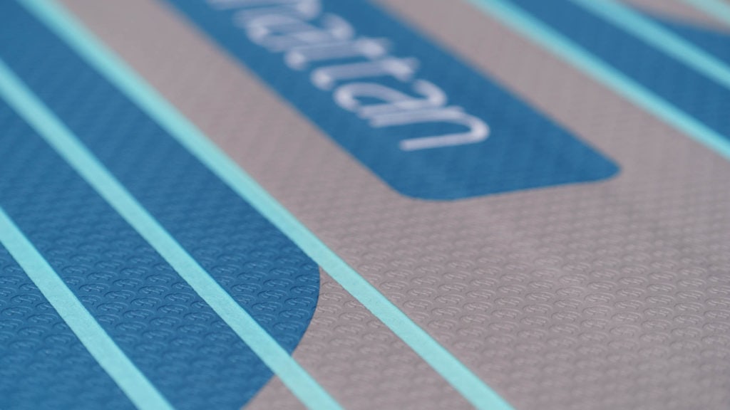 Detail of the deck texture with grooves and a light logo stamping for grip.