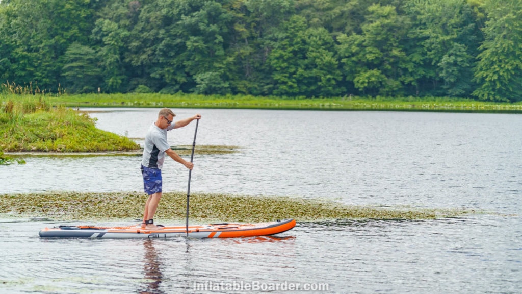 Paddling the Adventure SUP on a river.