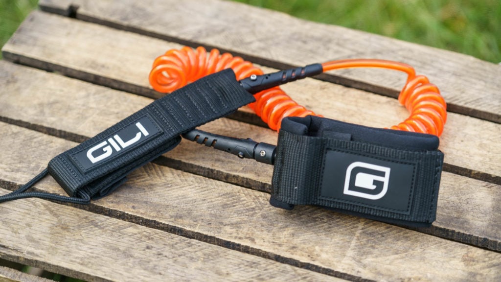 The coiled SUP leash is color matched to the board.