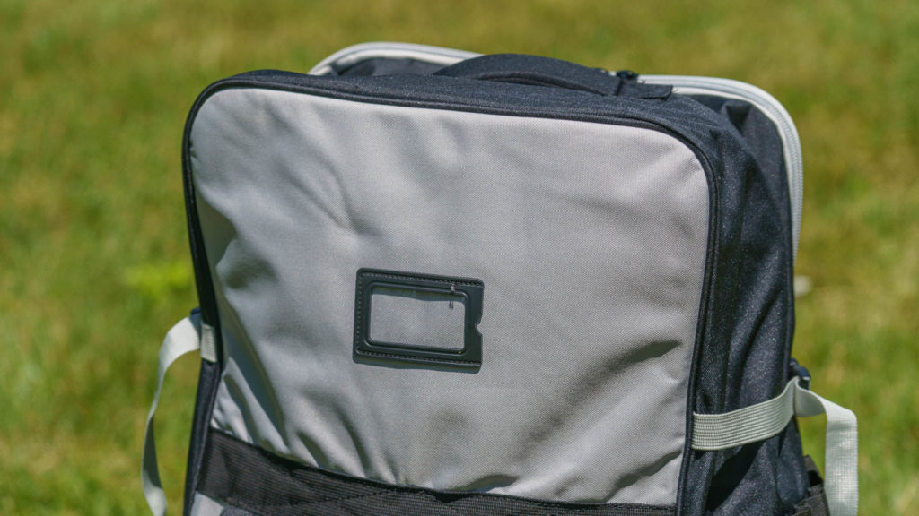 The rear of the bag has a small luggage tag window.