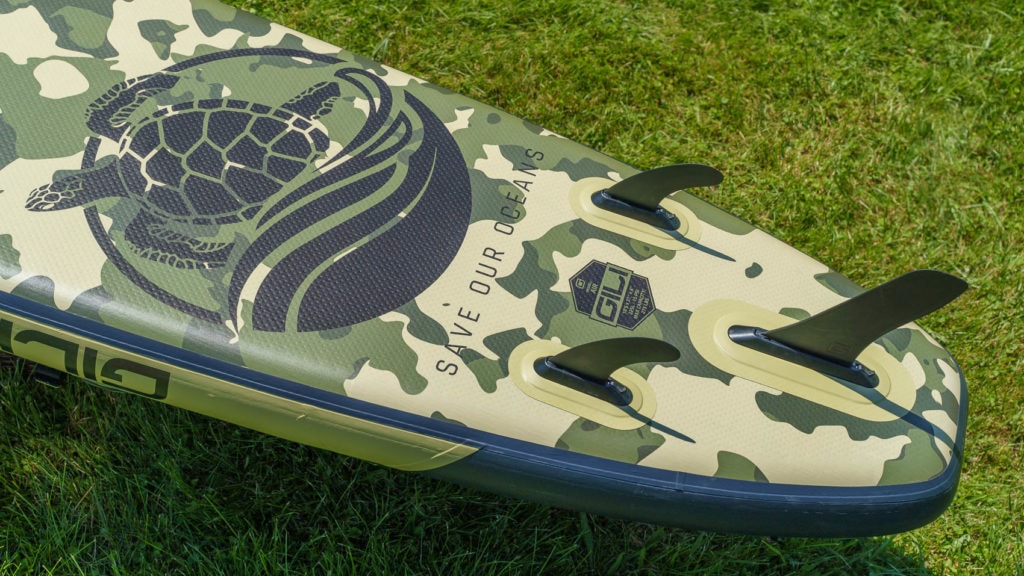 Bottom of the camo green 10'6 Air, with Save Our Oceans logo and 3 fins.
