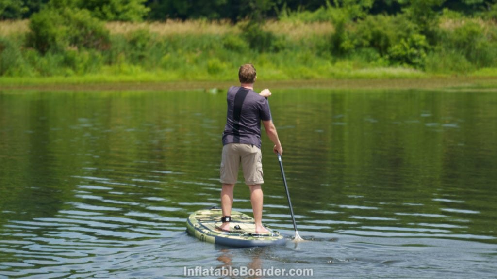 Paddling the board straight away on a calm lake.