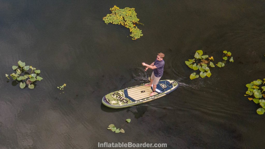 Paddling the SUP on a smooth lake.