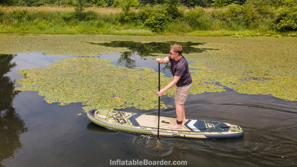 Paddling the SUP through a group of lily pads.