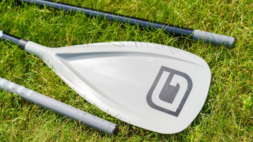 The paddle blade is gray plastic. The end of the paddle shaft is flat gray.